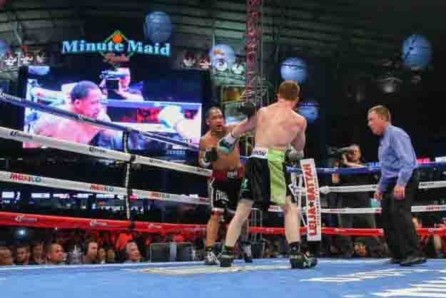 HOUSTON, TX - MAY 9: Saul "Canelo" Alvarez (black/green trunks) and James Kirkland (black/red trunks) during their 12 round super welterweight fight at Minute Maid Park on May  9, 2015 in Houston, Texas. (Photo by Ed Mulholland/Golden Boy/Golden Boy via Getty Images) *** Local Caption ***Saul Alvarez; James Kirkland