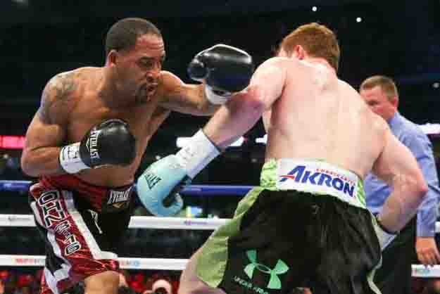 HOUSTON, TX - MAY 9: Saul "Canelo" Alvarez (black/green trunks) and James Kirkland (black/red trunks) during their 12 round super welterweight fight at Minute Maid Park on May  9, 2015 in Houston, Texas. (Photo by Ed Mulholland/Golden Boy/Golden Boy via Getty Images) *** Local Caption ***Saul Alvarez; James Kirkland